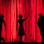 silhouette of three performers on stage